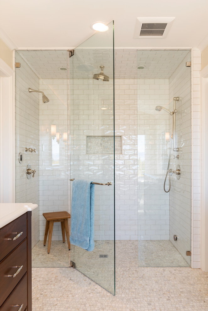 Traditional bathroom in Salt Lake City with flat-panel cabinets, dark wood cabinets, a curbless shower, white tile, subway tile, beige walls, mosaic tile floors, beige floor, a hinged shower door and white benchtops.