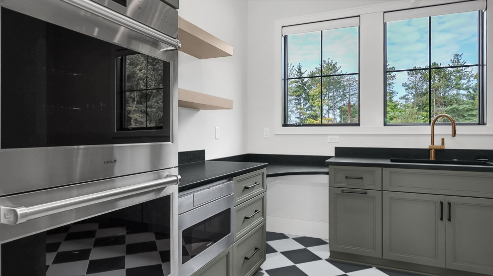 Transitional ceramic tile and multicolored floor kitchen photo in Columbus with an undermount sink, granite countertops, stainless steel appliances and black countertops