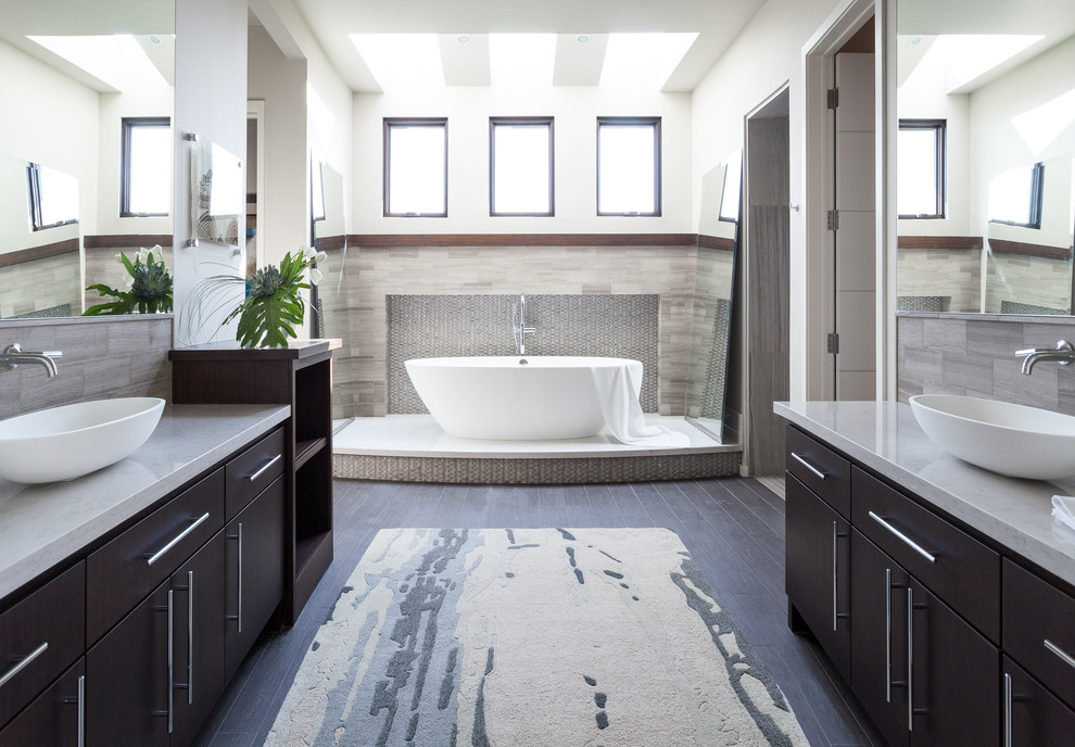 Inspiration for a large transitional master bathroom in Sacramento with a vessel sink, flat-panel cabinets, medium wood cabinets, engineered quartz benchtops, a freestanding tub, an open shower, beige tile, stone tile, white walls, porcelain floors and brown floor.