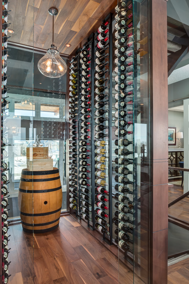 Transitional wine cellar in Calgary with medium hardwood floors and storage racks.