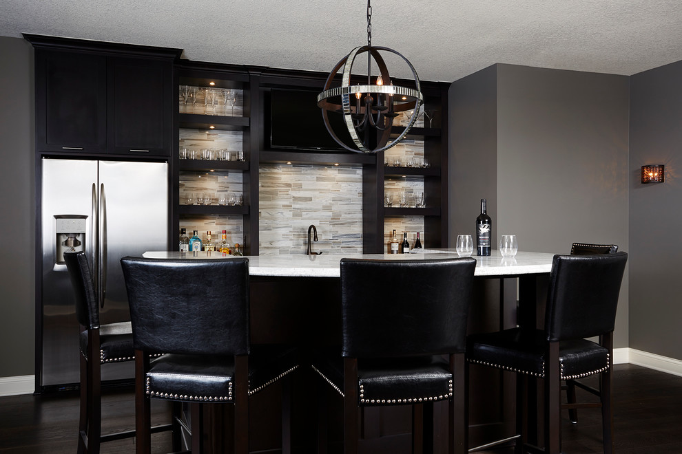 Photo of a large traditional seated home bar in Minneapolis with open cabinets, black cabinets, granite benchtops, multi-coloured splashback, dark hardwood floors, stone tile splashback and black floor.