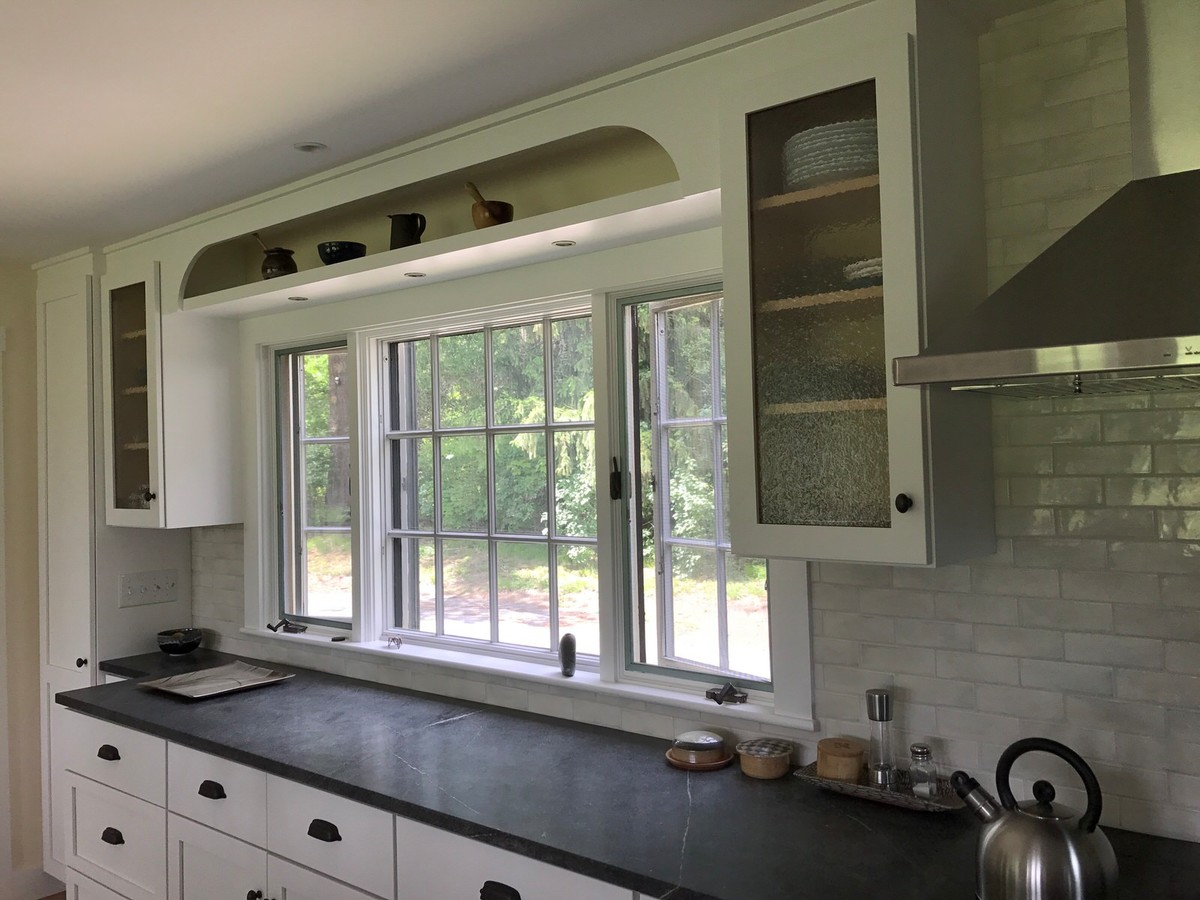 Photo of a mid-sized transitional galley eat-in kitchen in Boston with a single-bowl sink, shaker cabinets, white cabinets, soapstone benchtops, grey splashback, subway tile splashback, stainless steel appliances, medium hardwood floors and a peninsula.