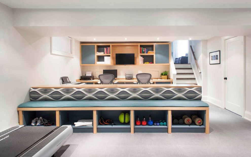 This is an example of a large contemporary fully buried basement in Toronto with white walls and grey floor.