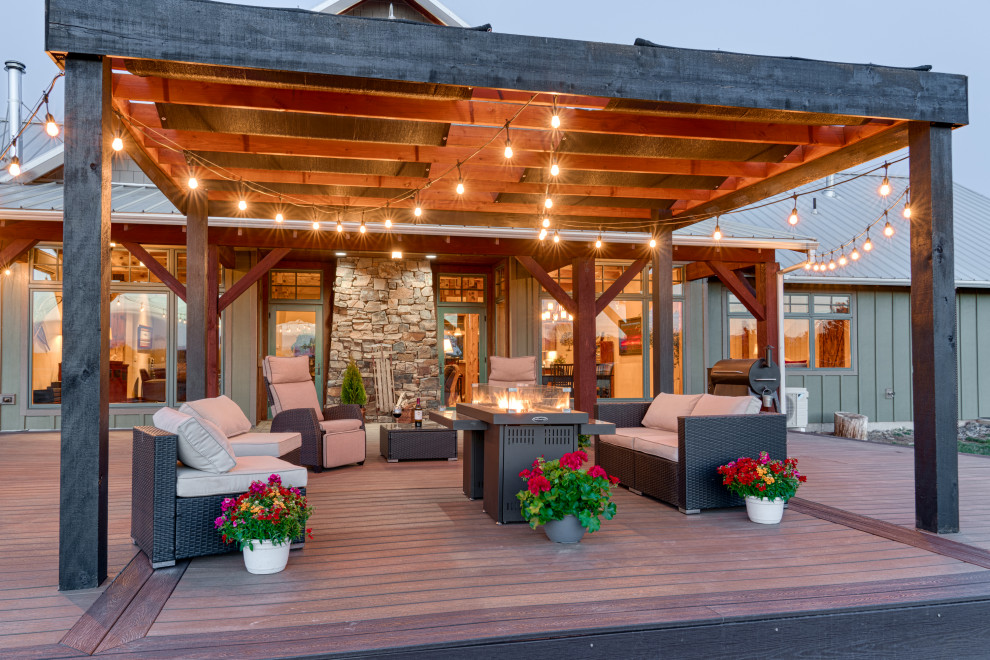 Deck - large cottage backyard deck idea in Other with a pergola