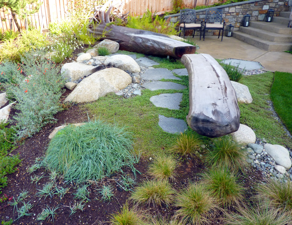 Design ideas for a beach style backyard partial sun garden in Seattle with natural stone pavers.