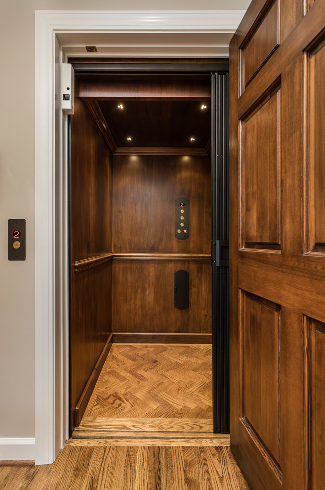 Small traditional hallway in Other with brown walls, medium hardwood floors and brown floor.