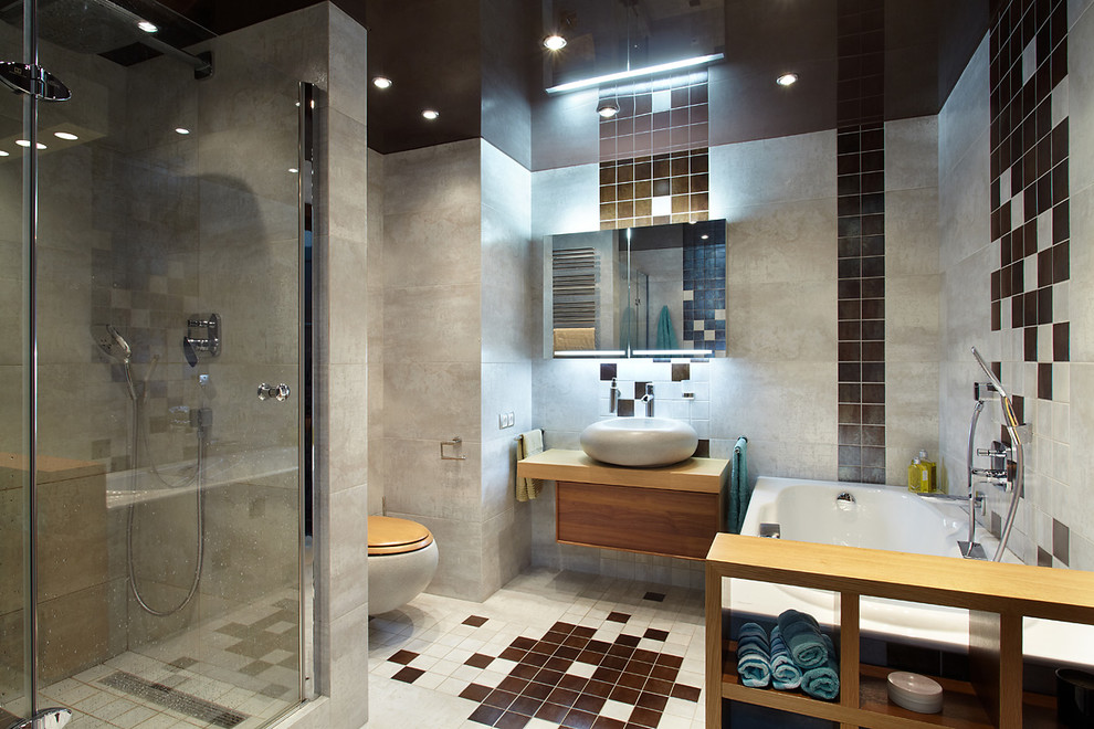 Mid-sized contemporary master bathroom in Saint Petersburg with flat-panel cabinets, medium wood cabinets, an alcove shower, a wall-mount toilet, brown tile, gray tile, multi-coloured walls, a vessel sink, a hinged shower door, an undermount tub, porcelain tile, porcelain floors and multi-coloured floor.