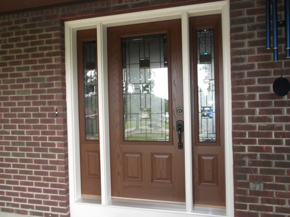 Transitional ceramic tile front door photo in Cleveland with brown walls and a medium wood front door
