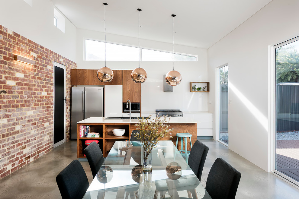 Photo of a contemporary open plan dining in Perth with white walls and concrete floors.