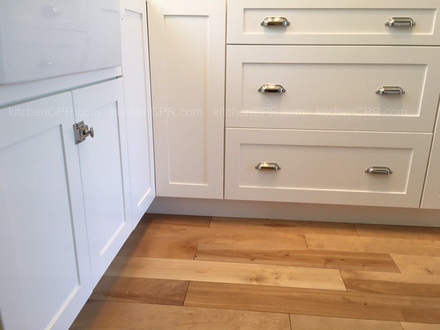 Inspiration for a small transitional u-shaped light wood floor eat-in kitchen remodel in Boston with recessed-panel cabinets, white cabinets and subway tile backsplash