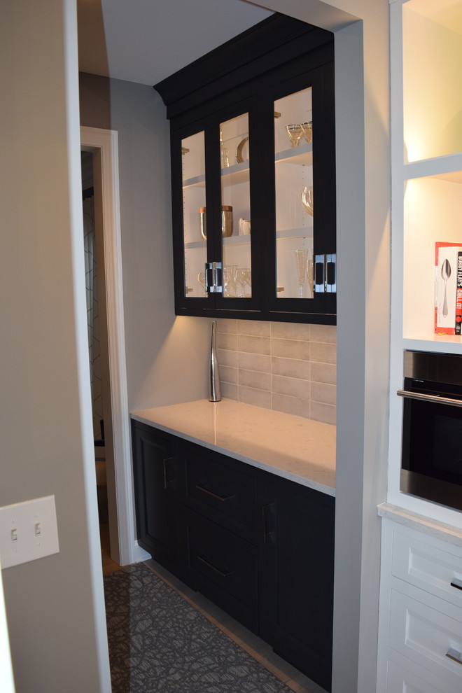 Large transitional l-shaped light wood floor and multicolored floor eat-in kitchen photo in Chicago with beaded inset cabinets, white cabinets, quartz countertops, black backsplash, ceramic backsplash, stainless steel appliances and an island