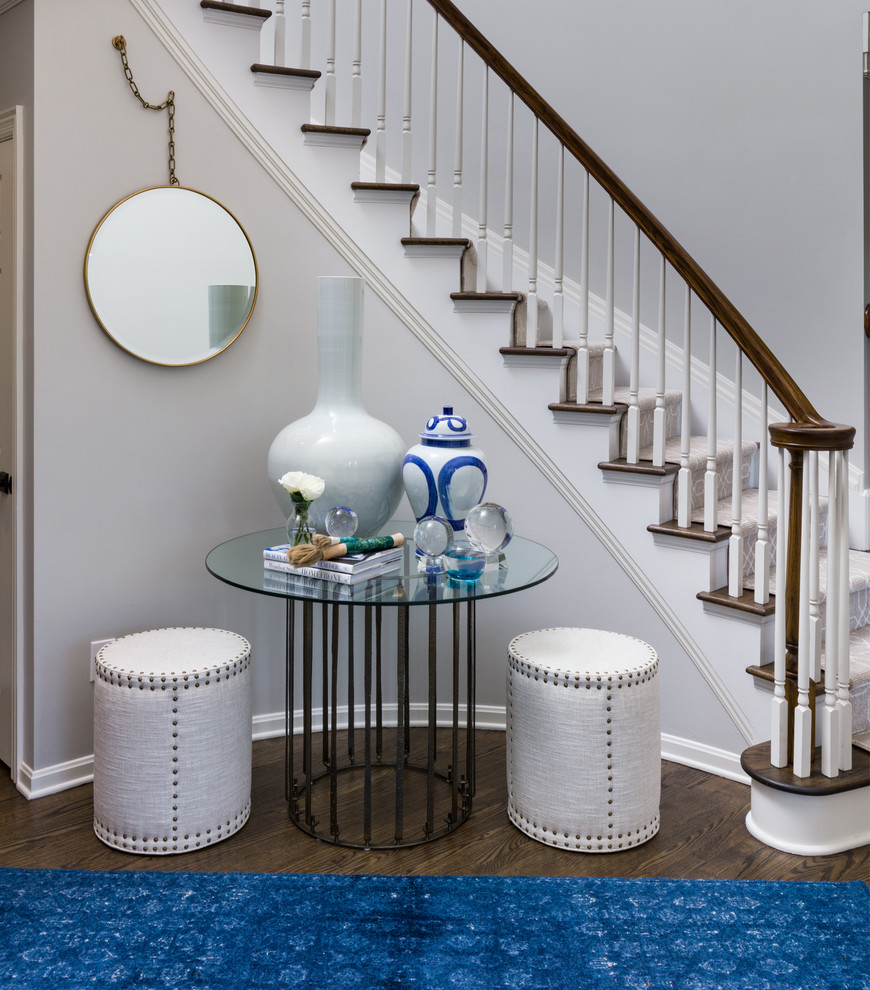 Example of a mid-sized transitional carpeted curved wood railing staircase design in Cleveland with carpeted risers
