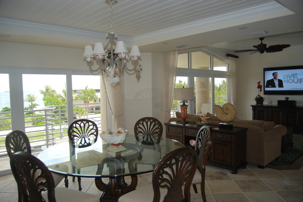 Design ideas for a large tropical open plan dining in Miami with travertine floors.