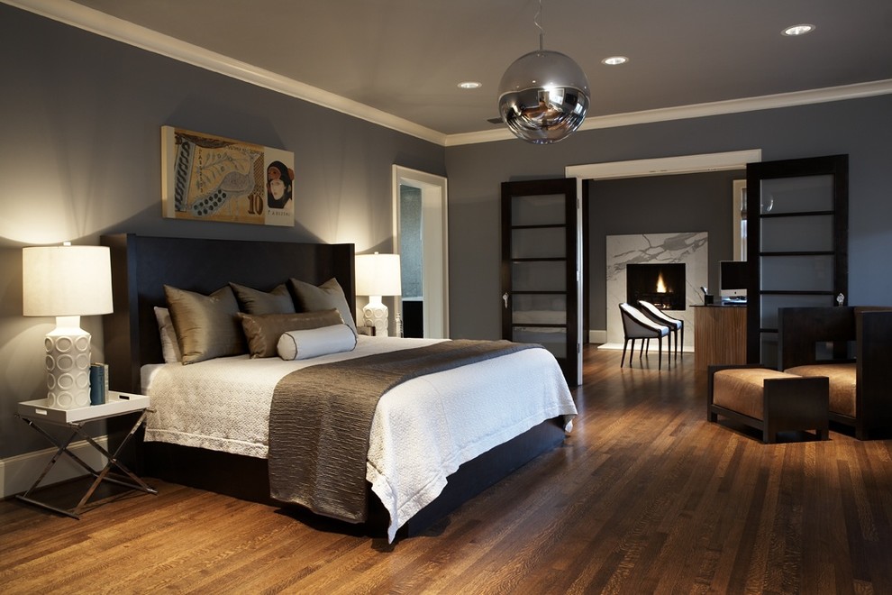 This is an example of a large contemporary master bedroom in Seattle with grey walls, dark hardwood floors, no fireplace and brown floor.