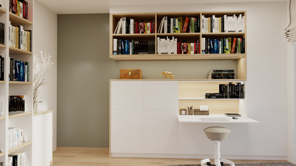 Inspiration för ett stort minimalistiskt arbetsrum, med ett bibliotek, gröna väggar, mellanmörkt trägolv och ett inbyggt skrivbord
