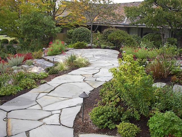 Mid-sized contemporary side yard garden in Seattle with natural stone pavers.