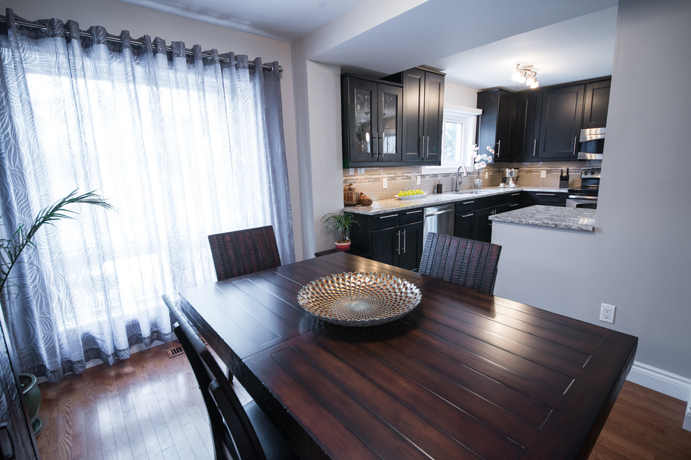 Example of a transitional porcelain tile kitchen/dining room combo design in Ottawa with an undermount sink, recessed-panel cabinets, quartz countertops, glass tile backsplash and stainless steel appliances