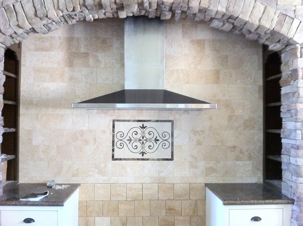 Mid-sized transitional l-shaped enclosed kitchen photo in Austin with an island, beige backsplash, stone tile backsplash and stainless steel appliances