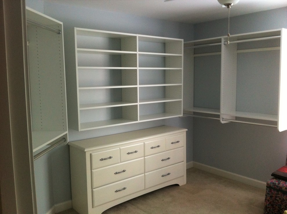 Design ideas for a mid-sized traditional gender-neutral walk-in wardrobe in Atlanta with open cabinets, white cabinets, carpet and beige floor.