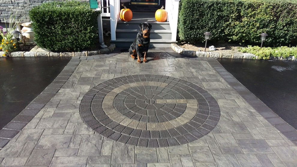Design ideas for a mid-sized arts and crafts front yard driveway in New York with concrete pavers.
