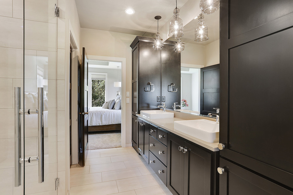 Inspiration for a transitional master ceramic tile bathroom remodel with shaker cabinets, dark wood cabinets, a vessel sink, quartz countertops and a hinged shower door