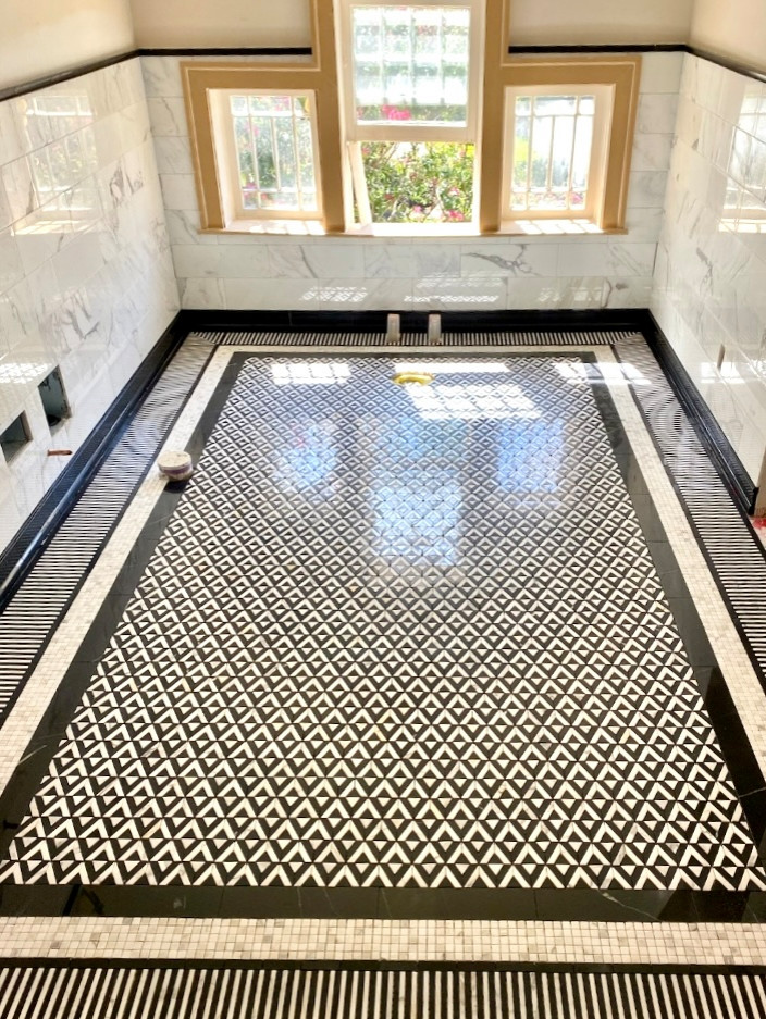 DURING: Retro Inspiration for a timeless bathroom addition and Attic Conversion in North Dallas, notice the intricate and stunning tile work on the floor and the walls.