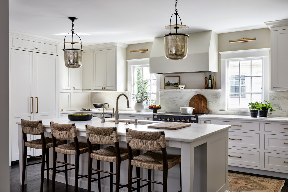 Example of a large transitional l-shaped dark wood floor and brown floor open concept kitchen design in DC Metro with an undermount sink, recessed-panel cabinets, white cabinets, marble countertops, white backsplash, granite backsplash, black appliances, an island and white countertops