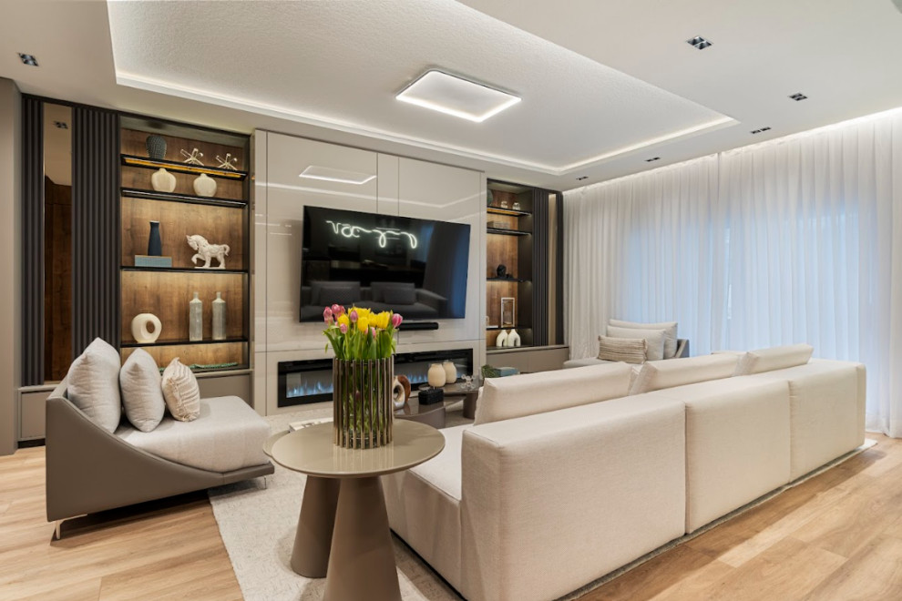 Photo of an expansive contemporary open concept living room in Tampa with a home bar, light hardwood floors, a built-in media wall, beige floor and recessed.
