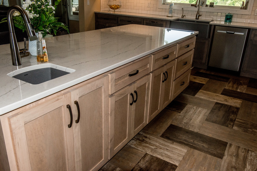Inspiration for a large transitional l-shaped vinyl floor and multicolored floor open concept kitchen remodel with a farmhouse sink, shaker cabinets, gray cabinets, quartz countertops, white backsplash, subway tile backsplash, stainless steel appliances, an island and white countertops
