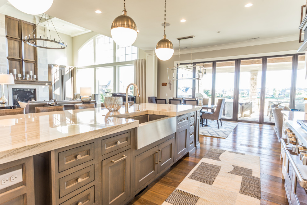 Example of a transitional l-shaped kitchen design with flat-panel cabinets and an island