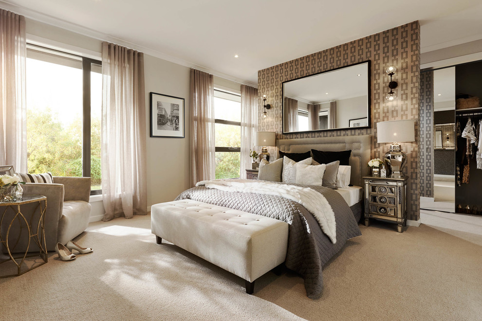 This is an example of a large contemporary master bedroom in Melbourne with beige walls and carpet.