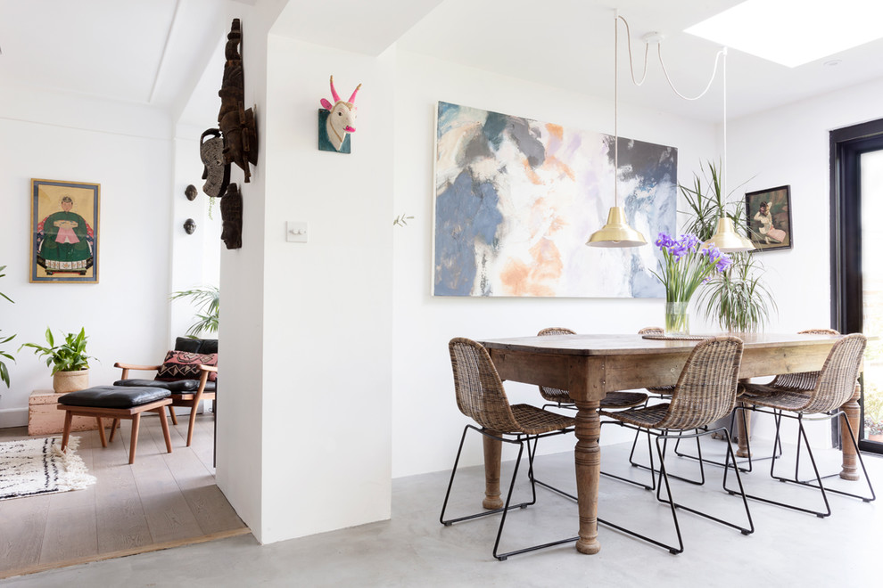 Photo of a large eclectic open plan dining in Edinburgh with white walls, concrete floors and grey floor.