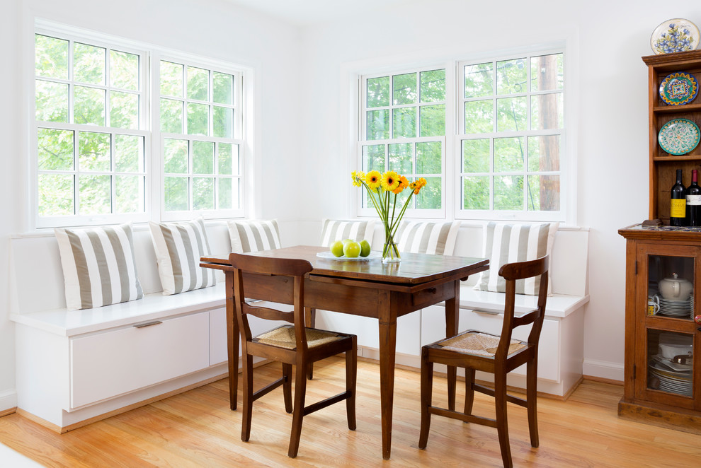 Design ideas for a traditional dining room in DC Metro with white walls and light hardwood floors.