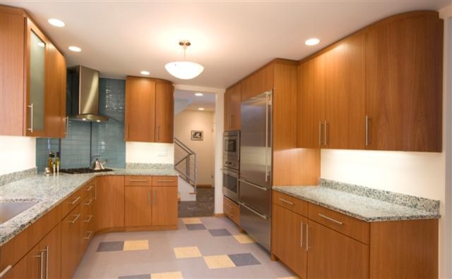 Large contemporary u-shaped separate kitchen in San Francisco with an undermount sink, shaker cabinets, medium wood cabinets, recycled glass benchtops, multi-coloured splashback, glass tile splashback, stainless steel appliances and linoleum floors.