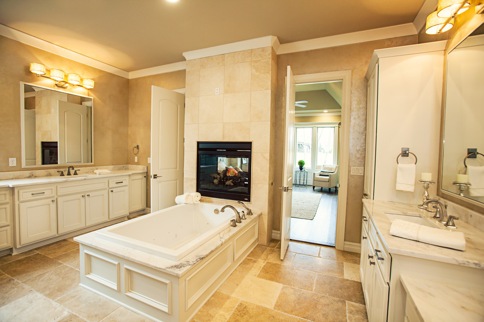 Inspiration for a large country master bathroom in Other with recessed-panel cabinets, white cabinets, a freestanding tub, a double shower, a two-piece toilet, beige tile, marble, beige walls, limestone floors, an undermount sink and marble benchtops.