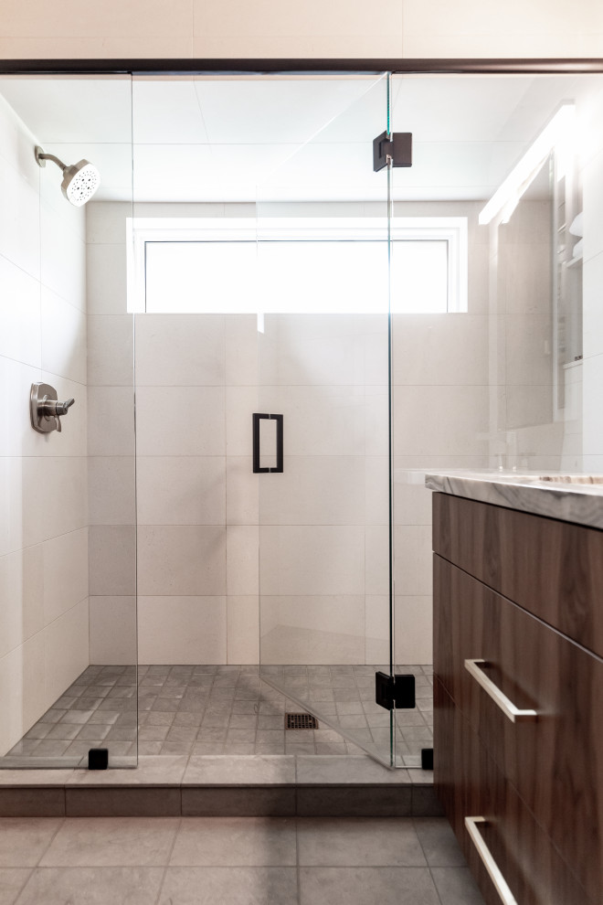 Small contemporary bathroom in Salt Lake City with flat-panel cabinets, medium wood cabinets, beige tiles, travertine tiles, limestone flooring, a built-in sink, onyx worktops, grey floors, a hinged door, a shower bench and a single sink.