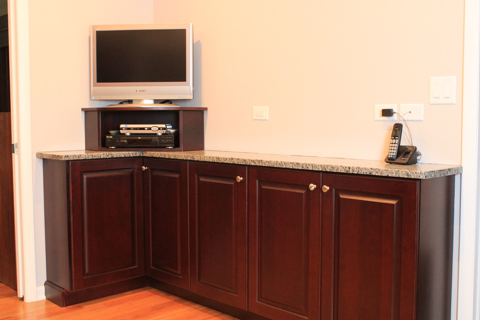 Inspiration for a mid-sized transitional u-shaped eat-in kitchen remodel with an undermount sink, raised-panel cabinets, dark wood cabinets, quartz countertops and gray backsplash