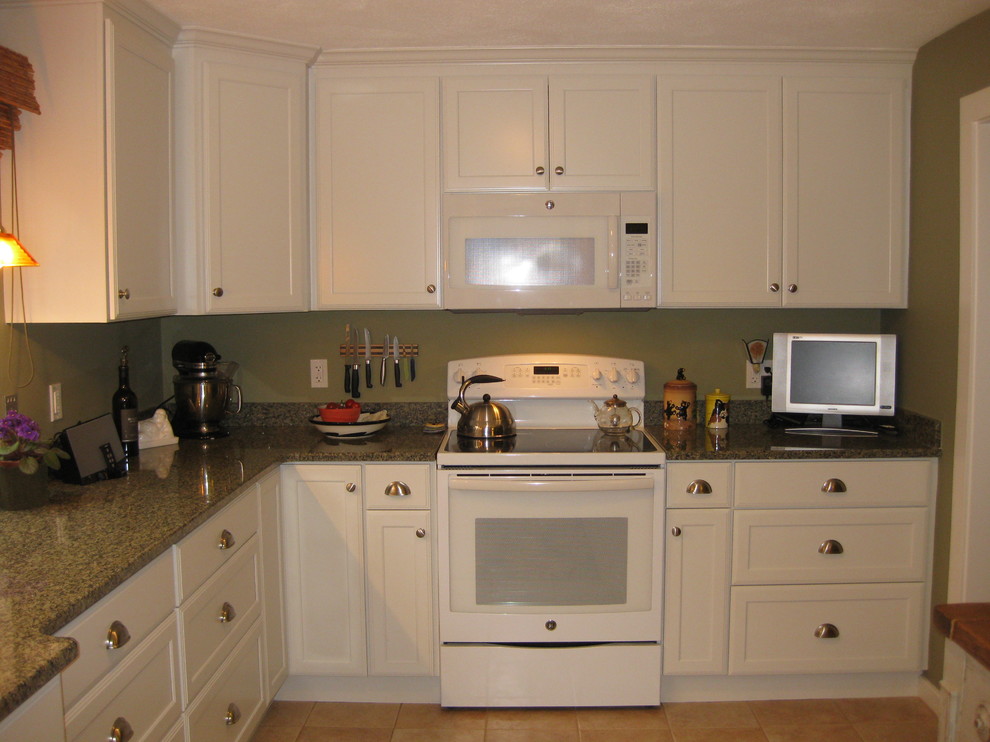 Kitchen - transitional l-shaped ceramic tile and beige floor kitchen idea in Boston with an undermount sink, shaker cabinets, white cabinets, granite countertops, white appliances and green countertops