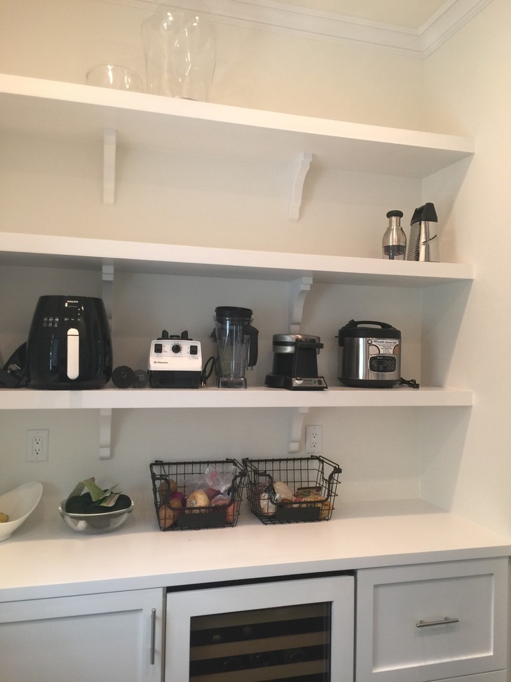 Large transitional u-shaped dark wood floor kitchen pantry photo in Orange County with recessed-panel cabinets, white cabinets and solid surface countertops
