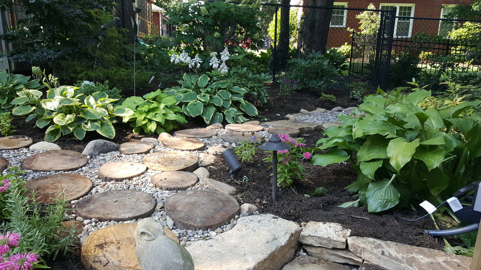 Inspiration for a large traditional backyard full sun garden in Huntington with a water feature and natural stone pavers.