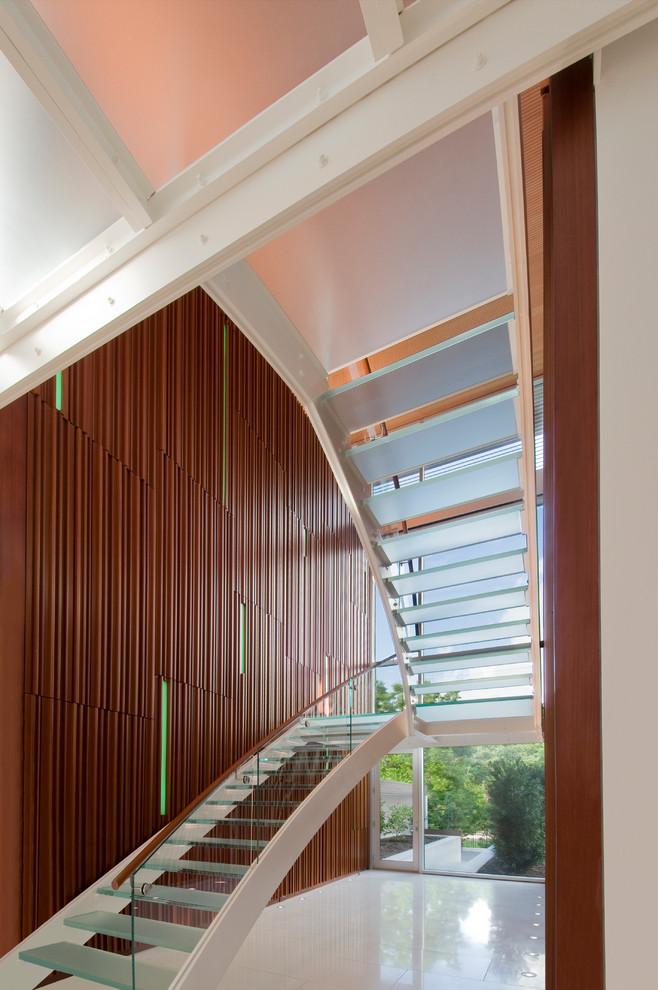Inspiration for a contemporary glass u-shaped staircase in Houston with open risers and glass railing.