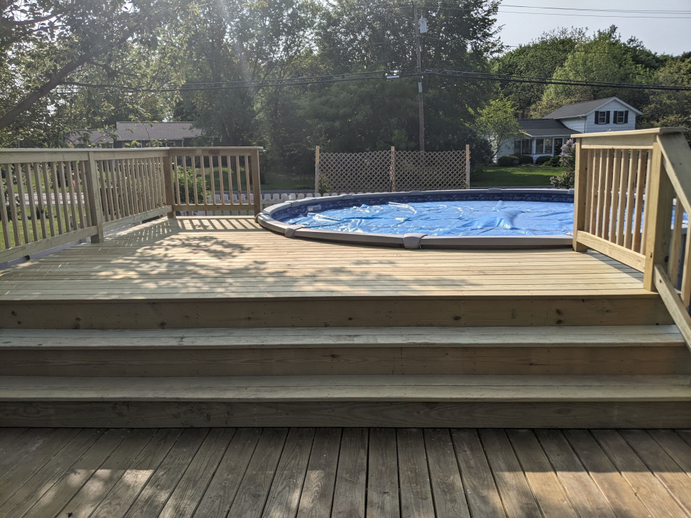 Deck - mid-sized backyard ground level wood railing deck idea with no cover