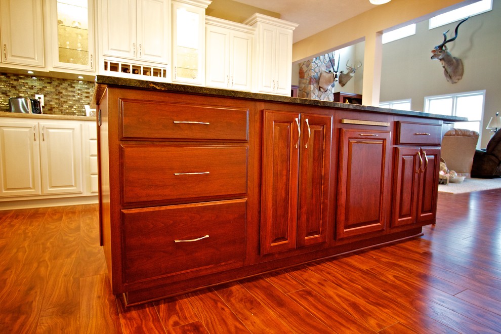 Inspiration for a large u-shaped medium tone wood floor open concept kitchen remodel with a drop-in sink, raised-panel cabinets, white cabinets, multicolored backsplash, glass tile backsplash, stainless steel appliances and an island
