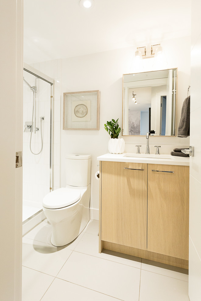 Design ideas for a small modern kids bathroom in Vancouver with light wood cabinets, an alcove shower, a two-piece toilet, white tile, ceramic tile, white walls, porcelain floors, an undermount sink, engineered quartz benchtops, grey floor, a sliding shower screen and white benchtops.