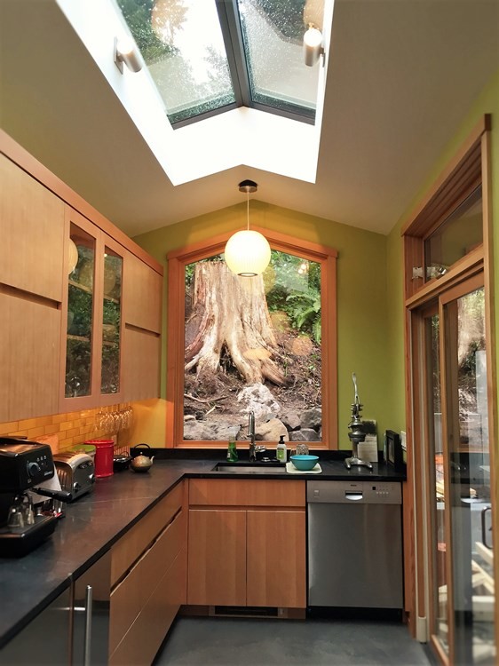 Example of a mid-sized trendy l-shaped concrete floor and gray floor enclosed kitchen design in Seattle with an undermount sink, flat-panel cabinets, medium tone wood cabinets, quartz countertops, brown backsplash, subway tile backsplash, stainless steel appliances and no island