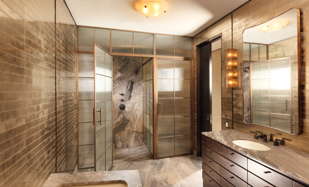 Inspiration for an expansive contemporary master bathroom in New York with dark wood cabinets, marble benchtops, an alcove shower, brown tile, metal tile, brown walls, marble floors, an undermount tub and flat-panel cabinets.