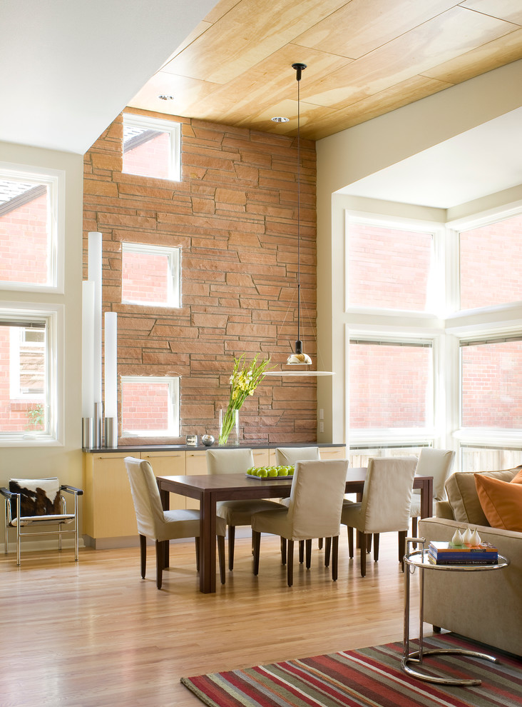 Photo of a contemporary open plan dining in Denver with white walls and medium hardwood floors.