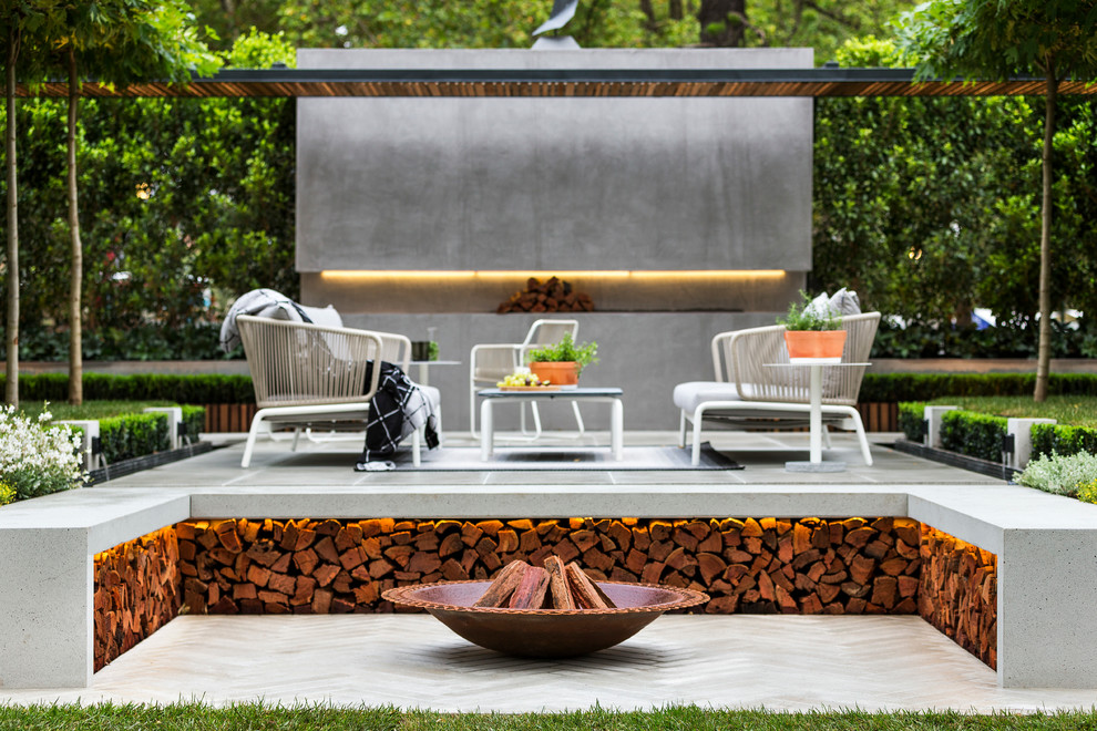 Design ideas for a contemporary patio in Melbourne with a fire feature and concrete pavers.