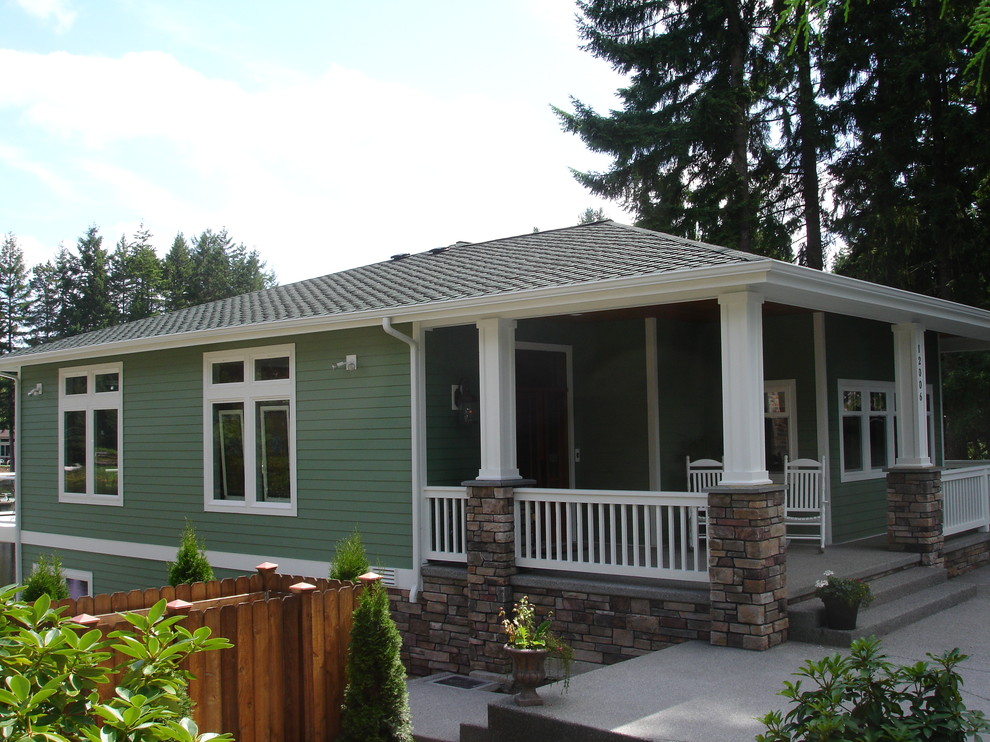 Mid-sized arts and crafts two-storey green house exterior in Seattle with concrete fiberboard siding, a gable roof and a shingle roof.