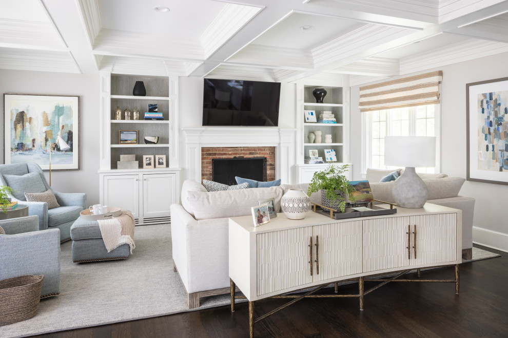 Inspiration for a transitional open concept living room in New York with grey walls, dark hardwood floors, a standard fireplace, a brick fireplace surround, a wall-mounted tv, brown floor and coffered.